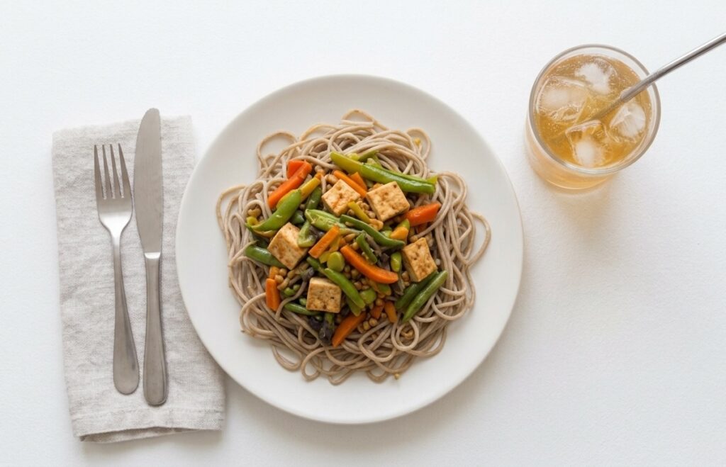 Tofu, noodles and veggies like beans and carrots with tea