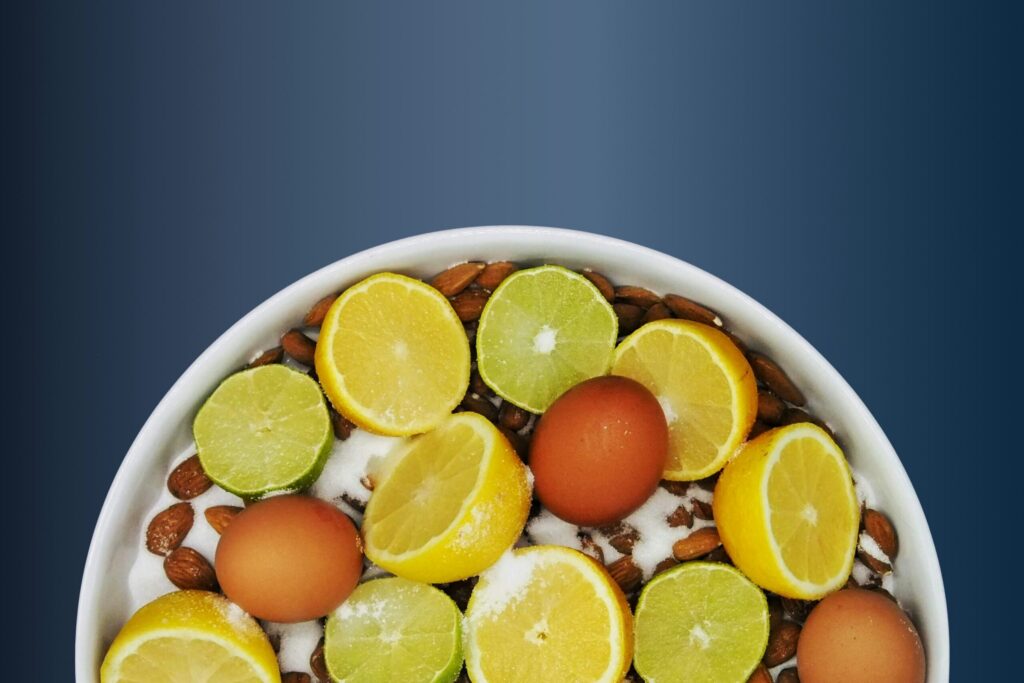 Limes and kiwi in a bowl of yogurt and oats on a navy blue background